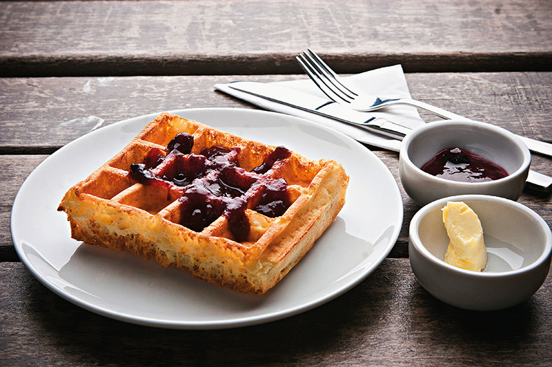 O crocante waffle com manteiga e geleia de frutas vermelhas O crocante waffle com manteiga e geleia de frutas vermelhas
