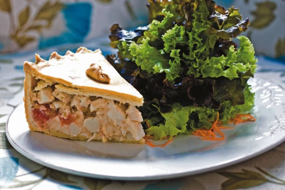 Fatia generosa de torta de palmito e tomate acompanhada de salada Fatia generosa de torta de palmito e tomate acompanhada de salada