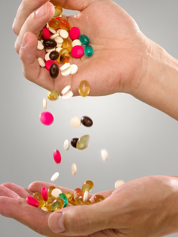 Person with pills and capsules
