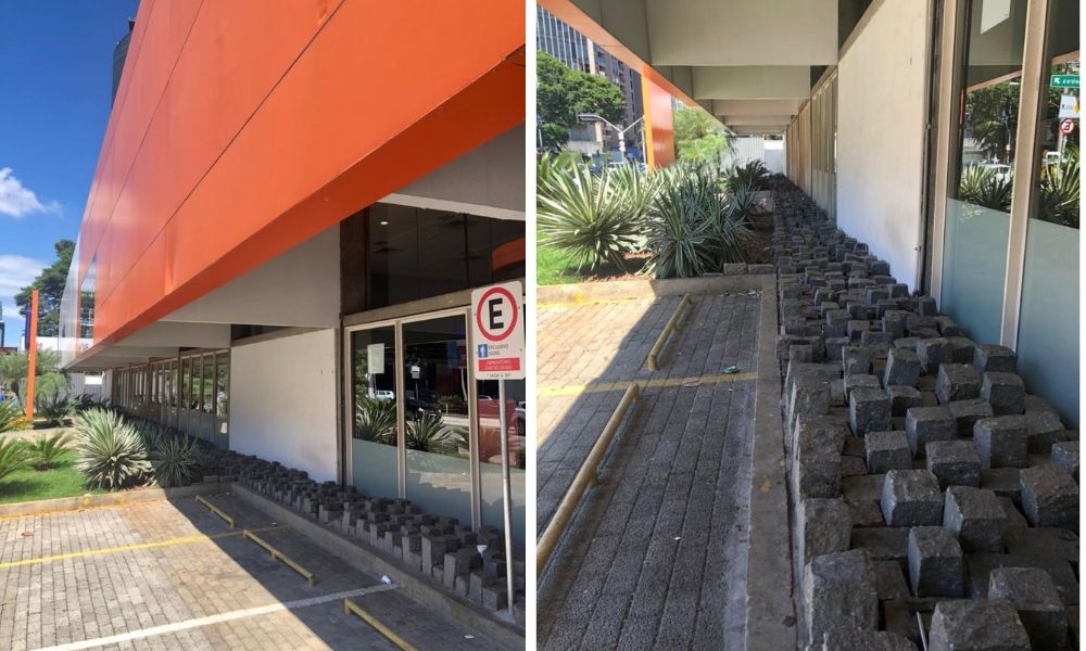Fachada de um banco Itaú com diversos pedregulhos irregulares com intuito de evitar que pessoas deitem ali