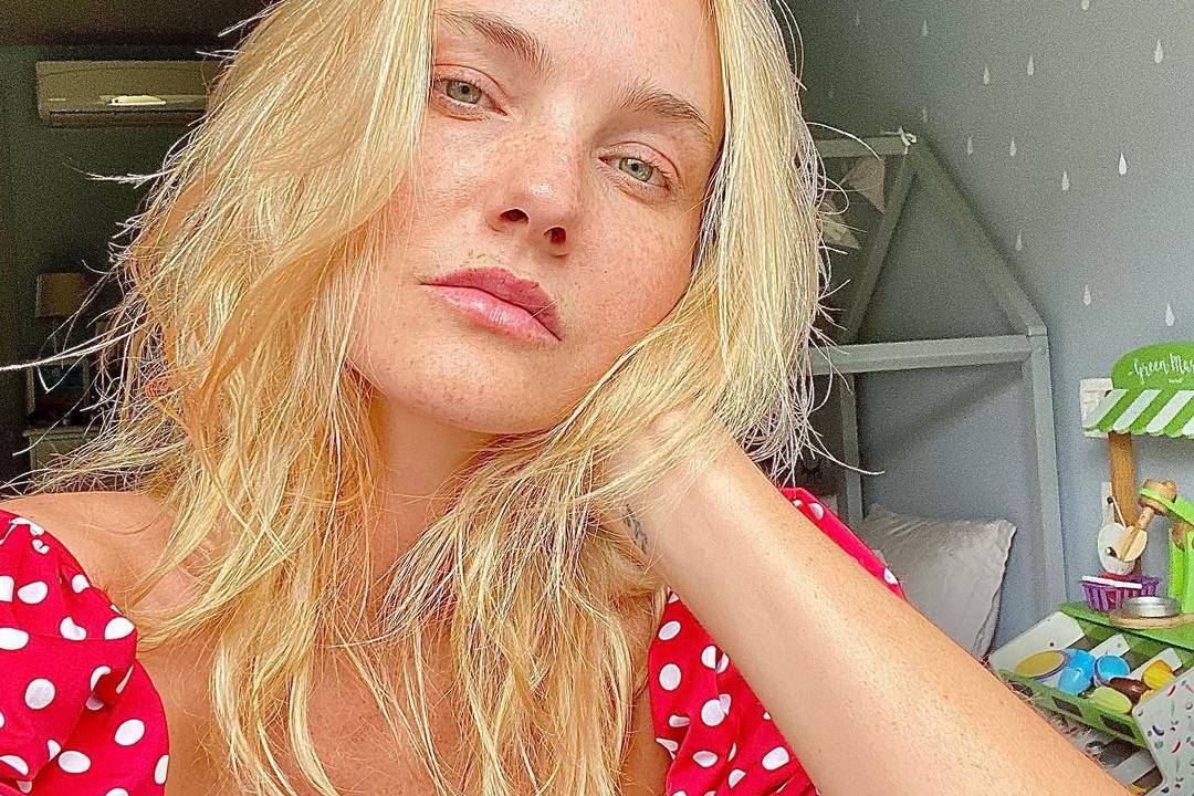 caroline olhando para a câmera com a cabeça apoiada em um dos braços