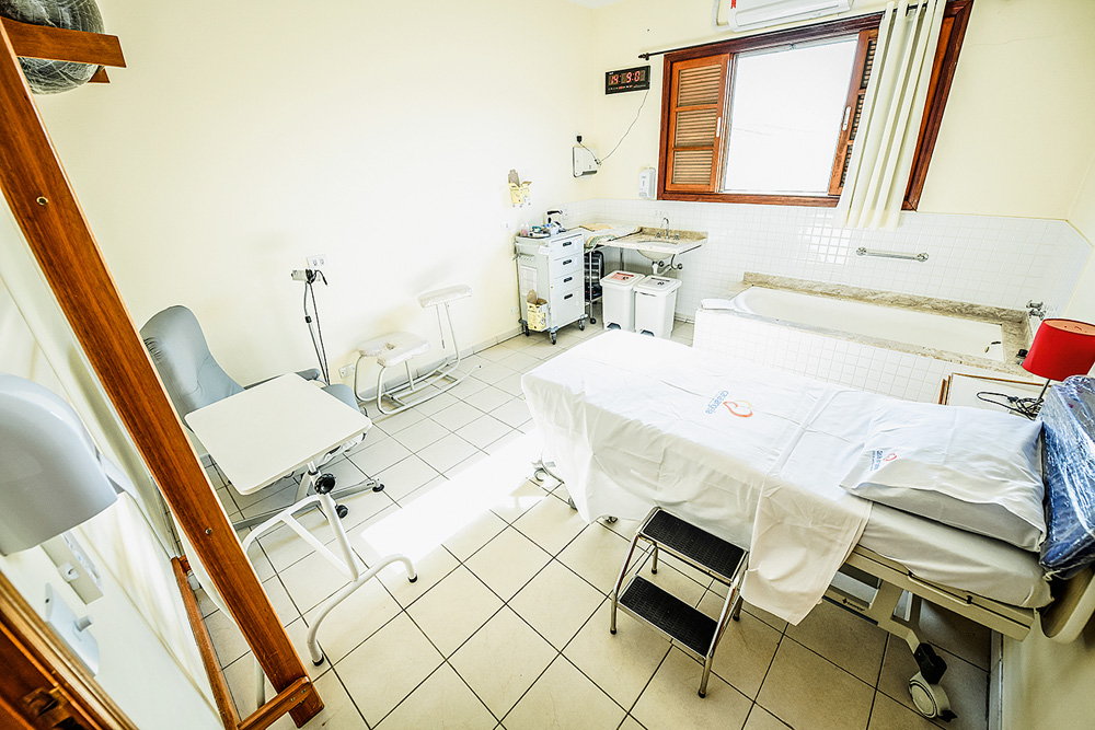 CASADEPARTO_2.JPG Sala de parto na Casa Angela. Maca, banco, pia e aparelhos médicos. Foto tem luz da claridade mostrada pela janela