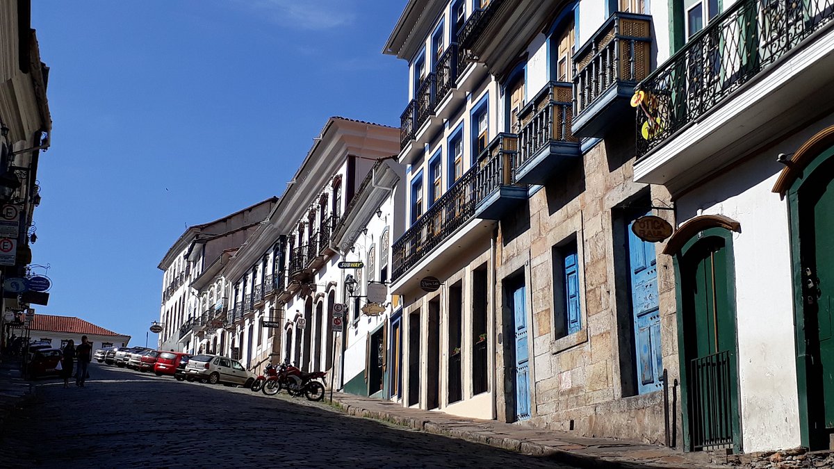 A imagem mostra uma rua com vários casarões coloniais