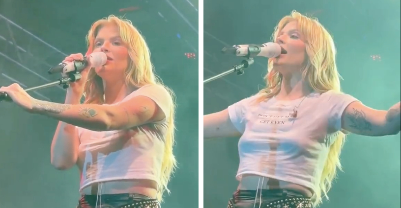 uma mulher branca, loira, de cabelos compridos cantando em cima de um palco