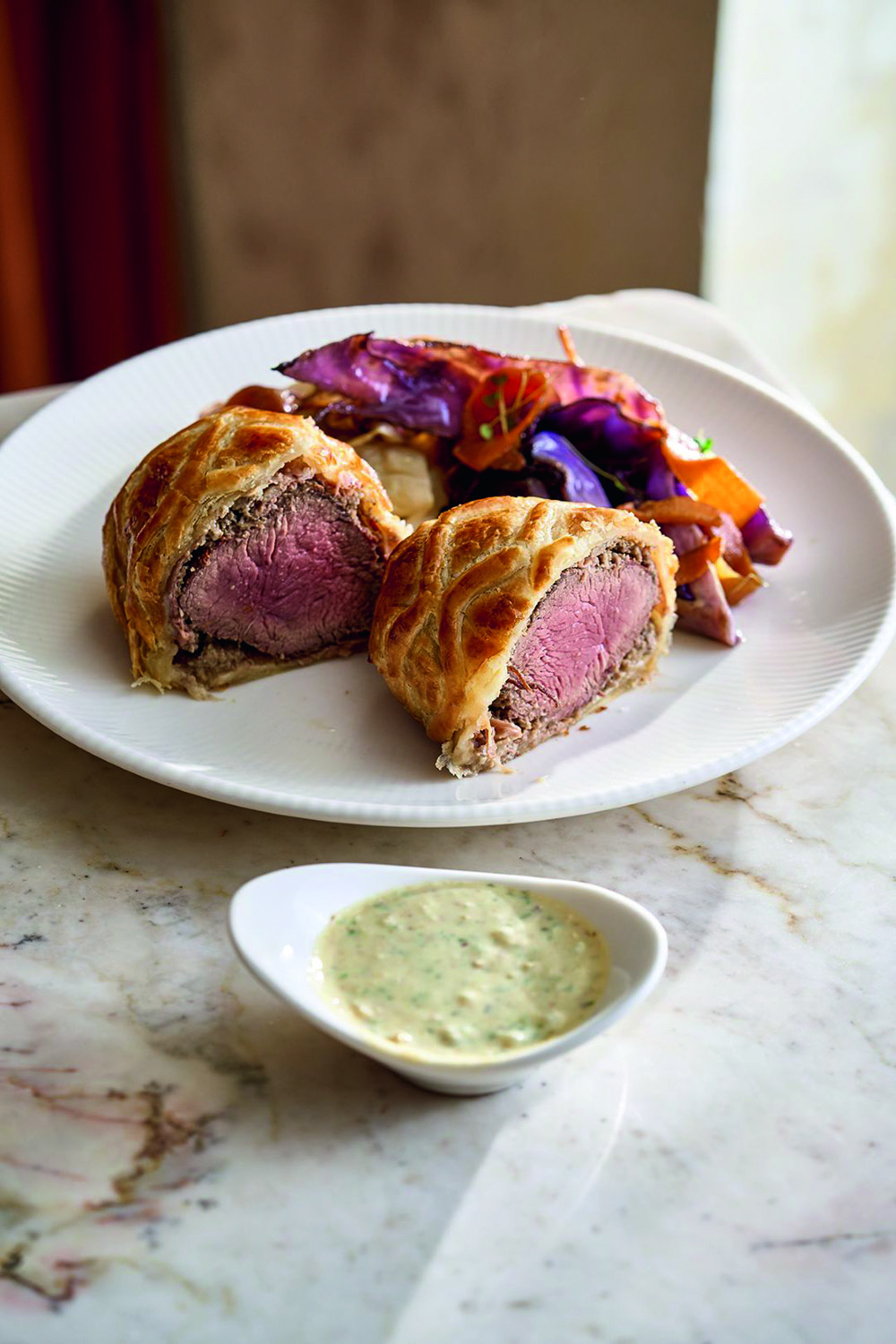 A Casa de Antonia_Beef Wellington_créd Studio Mió 2.jpg Carne em prato branco e molho ao lado