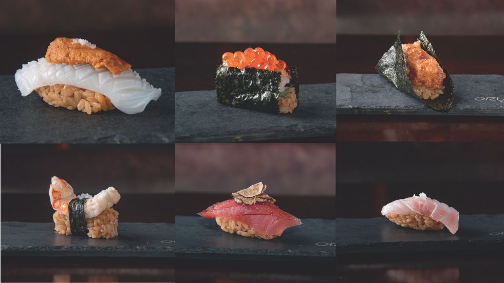 Seis sushis enfileirados da degusta&ccedil;&atilde;o em pratos cinzas