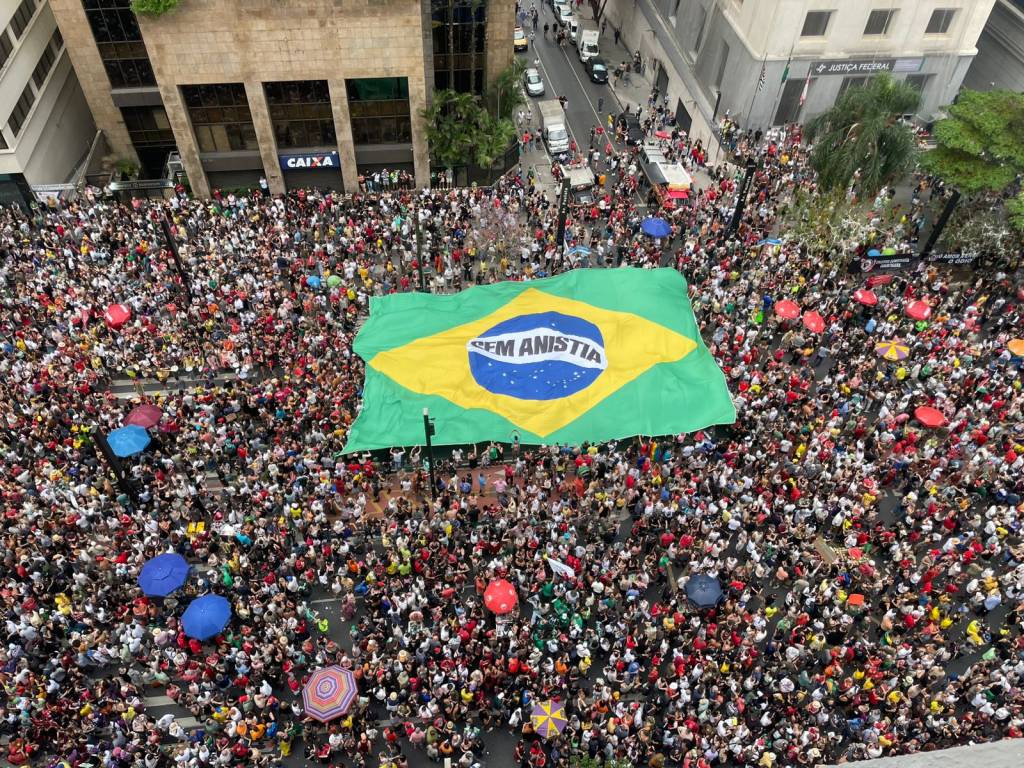 Com chuva e bandeira gigante do Brasil, multidões protestam na Paulista contra anistia