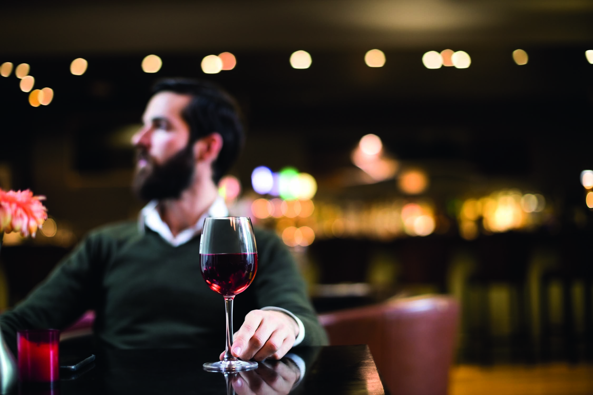 Man sitting with glass of wine in bar