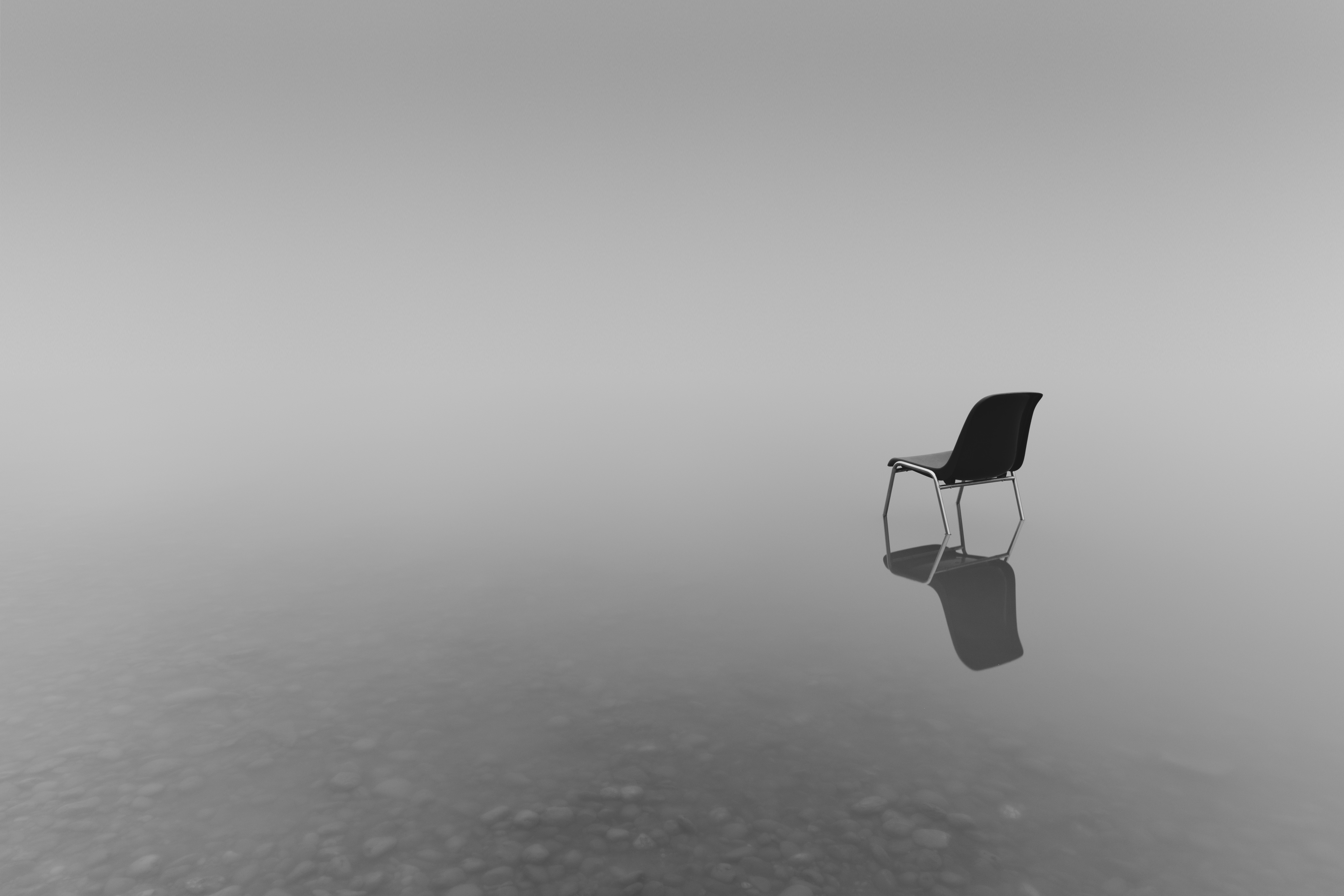 grayscale-shot-chair-small-pond-concept-loneliness