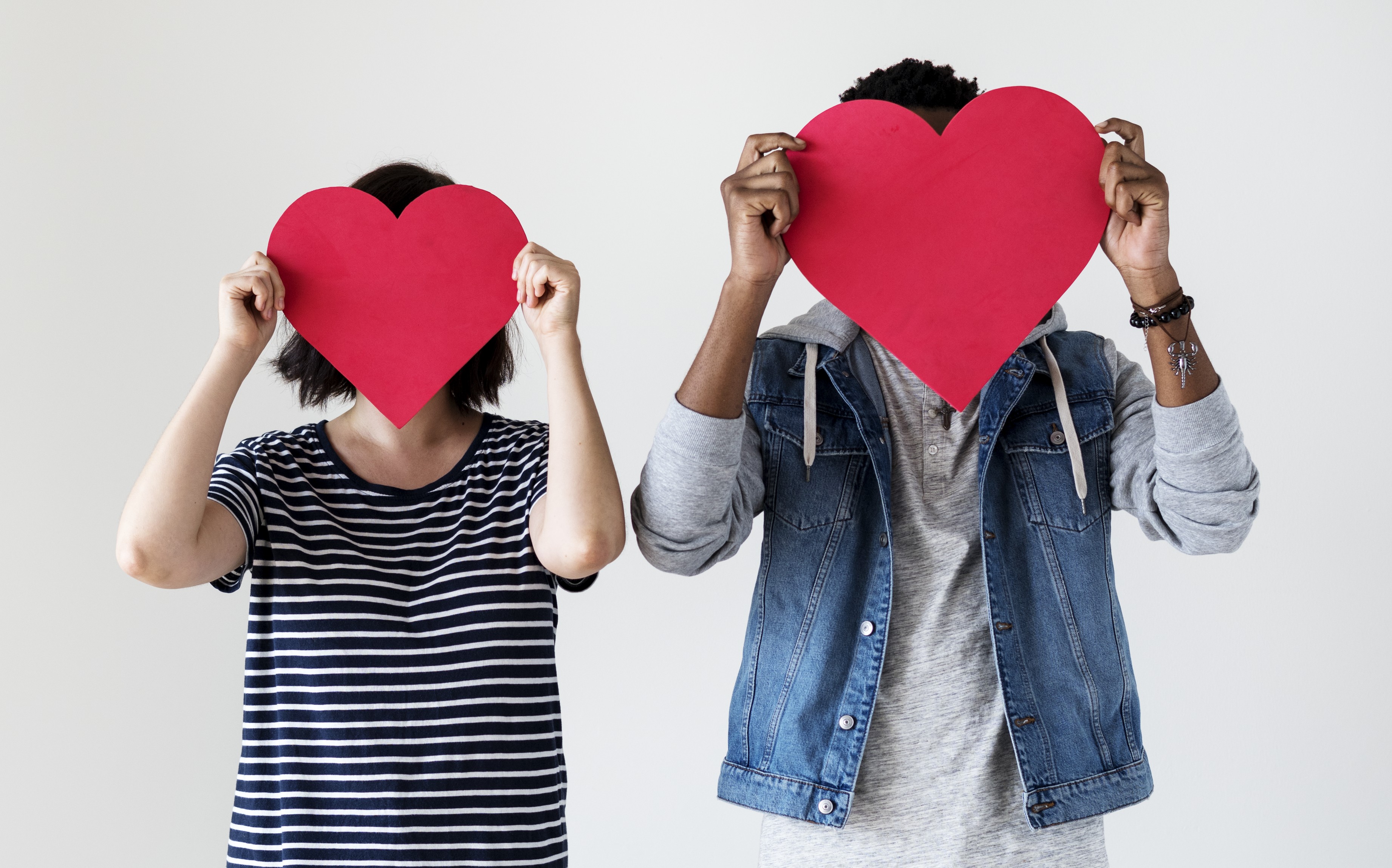 happy-couple-holding-red-heart-icons